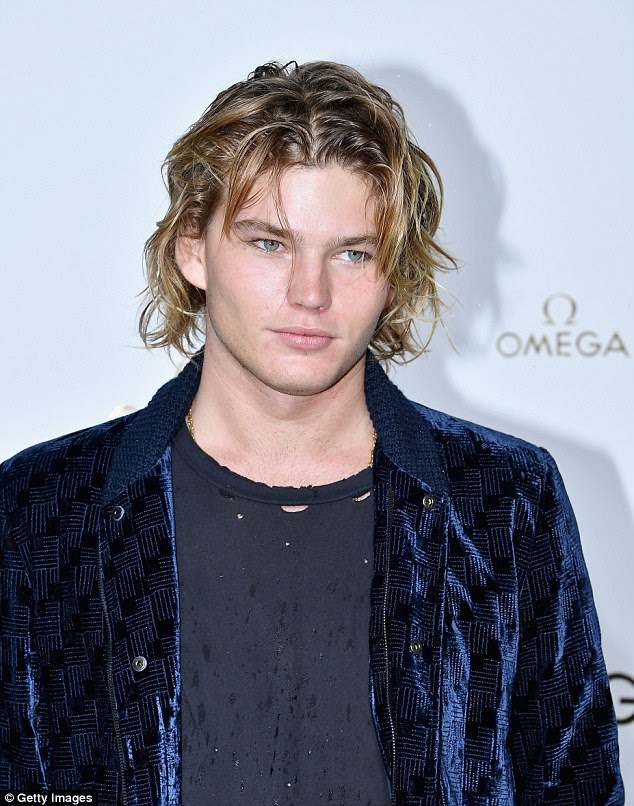Handsome: Jordan Barrett showcased his muscular body in the form-fitting top, which was torn for an edgy effect