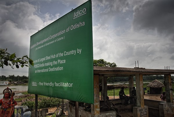 A signboard outside the village of Bailatutha. The bus stand behind it now serves as a make shift Police camping spot, keeping an eye on the movements of people in, out and around the proposed area. Image by Ayush Ranka. Copyright Demotix (22/7/2011)