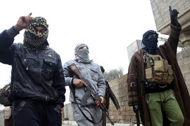 Gunmen fighters walk in the Gunmen fighters walk in the streets of the city of Falluja, 50 km (31 miles) west of Baghdad