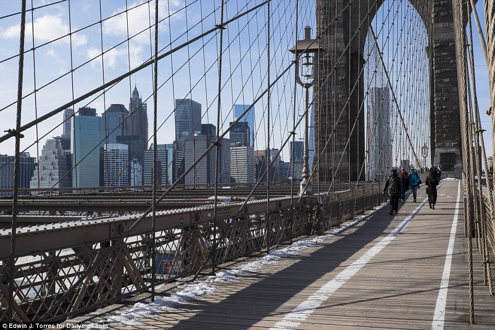 The Brooklyn Bridge today looks much the same - but the still wooden path has been marked out for cyclists and walkers