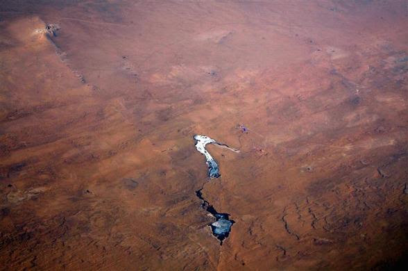 A frozen lake is seen among sand dunes in the Gobi Desert located south of the Mongolian capital city of Ulaanbaatar, April 3, 2012. REUTERS-David Gray