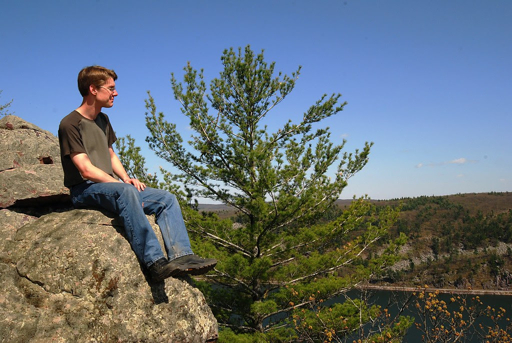 Me, enjoying the view while sitting on a steep cliff edge.