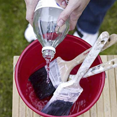 cleaning brushes in a bucket of vinegar