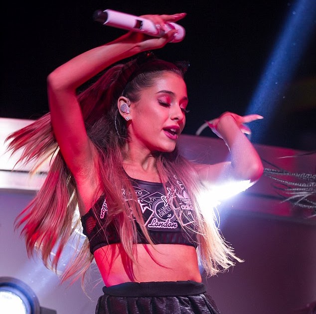 KATCHING MY I: Ariana Grande shows off toned stomach in leather bra and ...