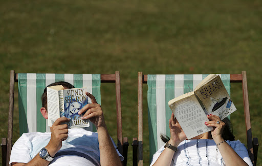 A couple read on deck chairs in Green Park in central London as temperatures soar on September 14, 2016.  Britain continued to enjoy sizzling heat on September 14, after temperatures soared to to 34.4 in Kent south east England on September 13, the hottest September day in over a century.  / AFP PHOTO / Daniel Leal-OlivasDANIEL LEAL-OLIVAS/AFP/Getty Images
