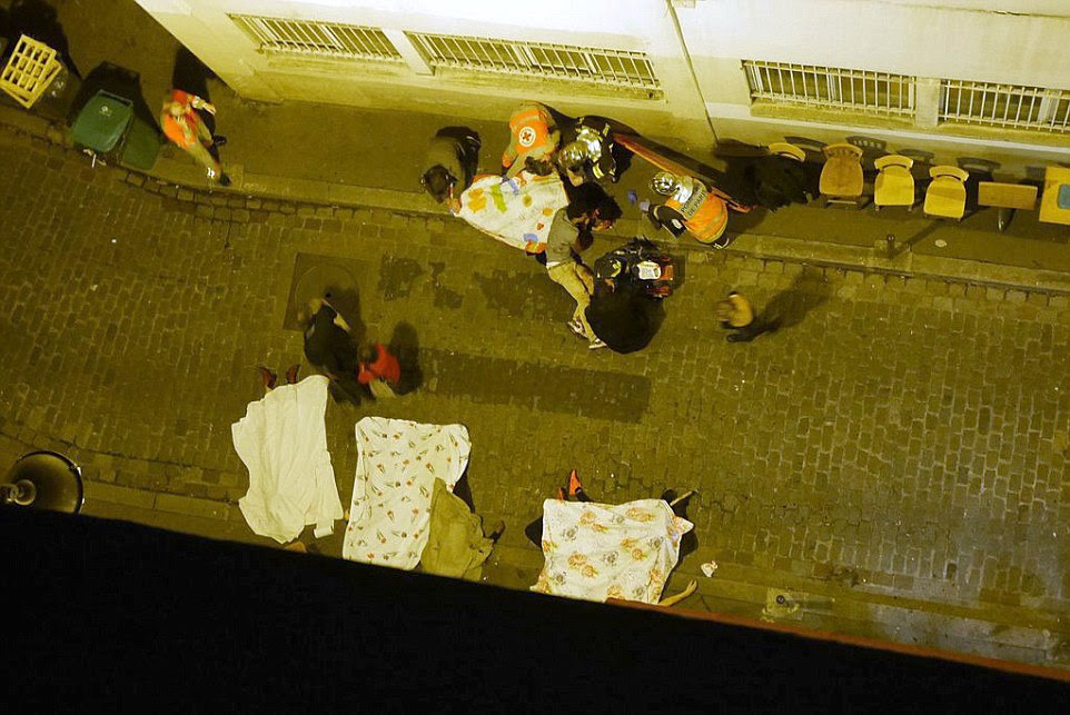 Bodies litter the streets of a Paris alley after a string of terror attacks in the French capital which led President Francois Hollande to declare a national state of emergency
