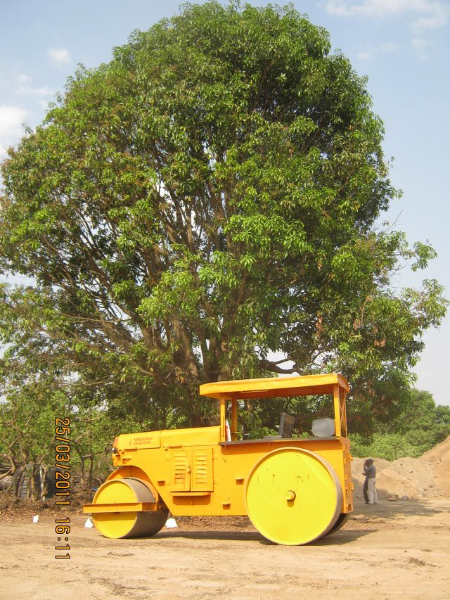 The yellow road-roller and the green tree at DSK Gandhakosh Baner Pune