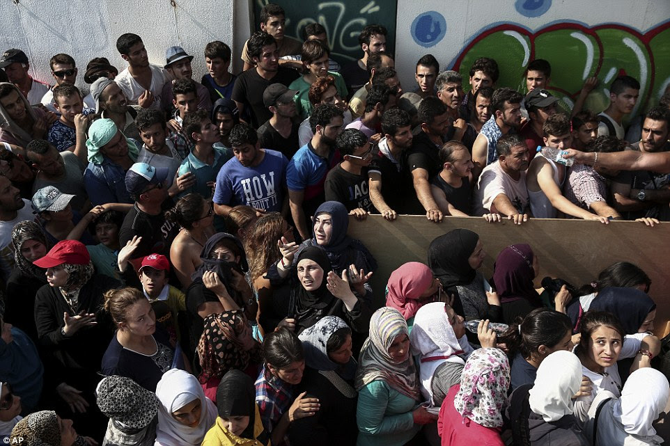 Despair: Hundreds of migrants gather for a registration procedure at the stadium of Kos town yesterday