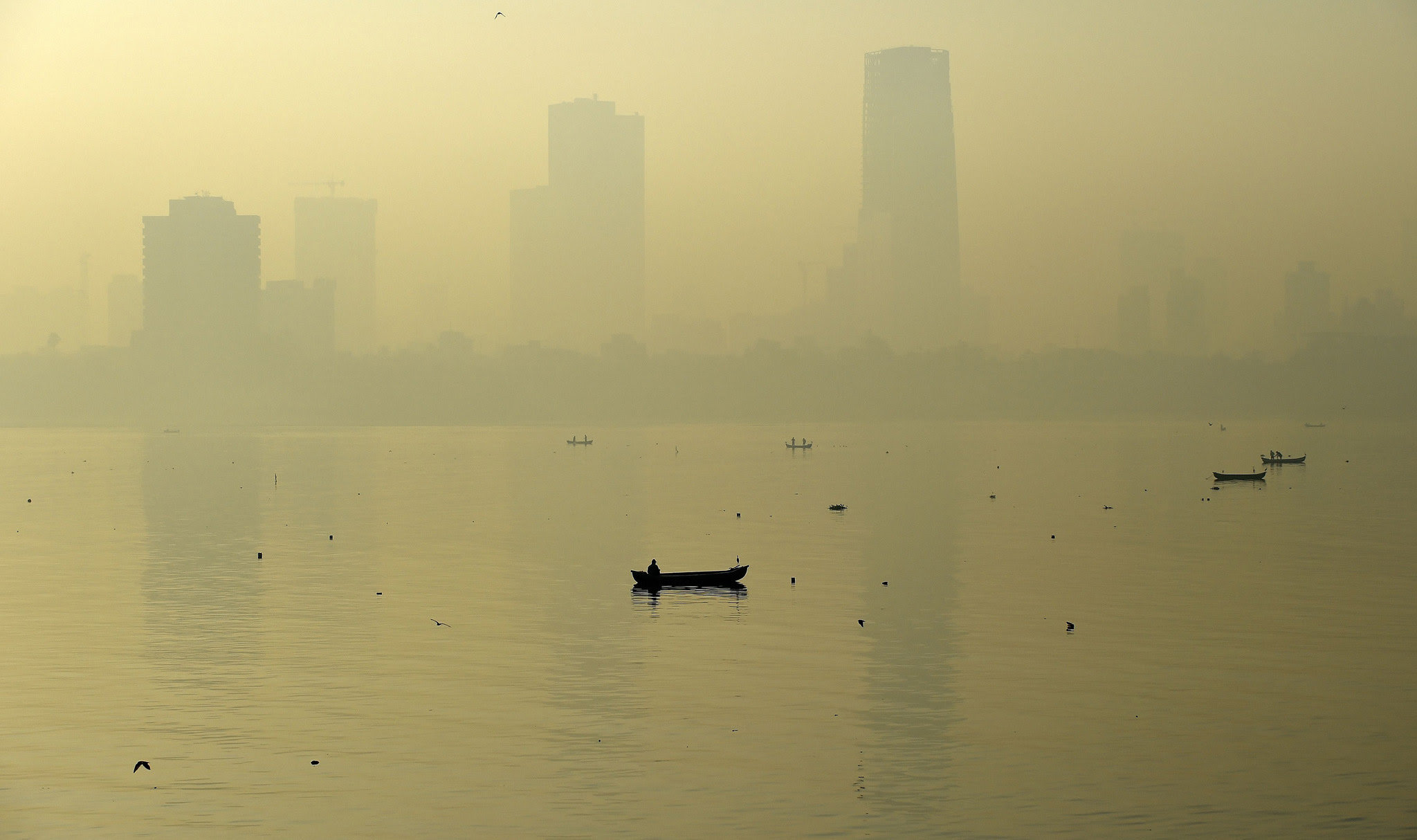 TOPSHOT - A fishing boat is seen in the ...TOPSHOT - A fishing boat is seen in the morning general view of the city skyline covered by a smoggy haze in Mumbai on January 29, 2016.  AFP PHOTO / PUNIT PARANJPE / AFP / PUNIT PARANJPEPUNIT PARANJPE/AFP/Getty Images