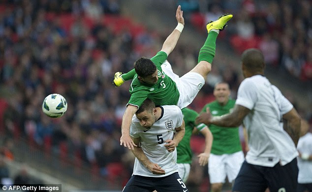 Taking a tumble: Ireland's Shane Long and England's Gary Cahill battle for an aerial ball