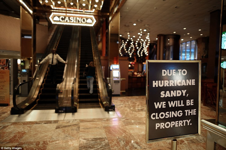 A sign announcing the closure of the Trump Casino stands in the lobby as Hurricane Sandy approaches Atlantic City, New Jersey