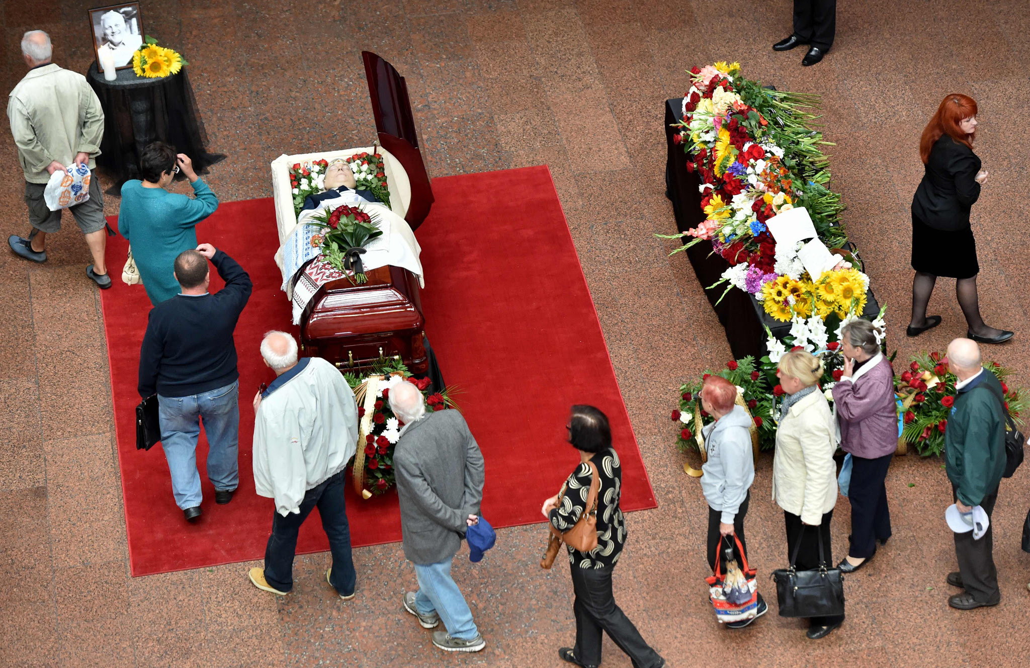 People pay tribute near the open casket of Belarus-born journalist Pavel Sheremet, who was killed in a car bomb in central Kiev on July 20,