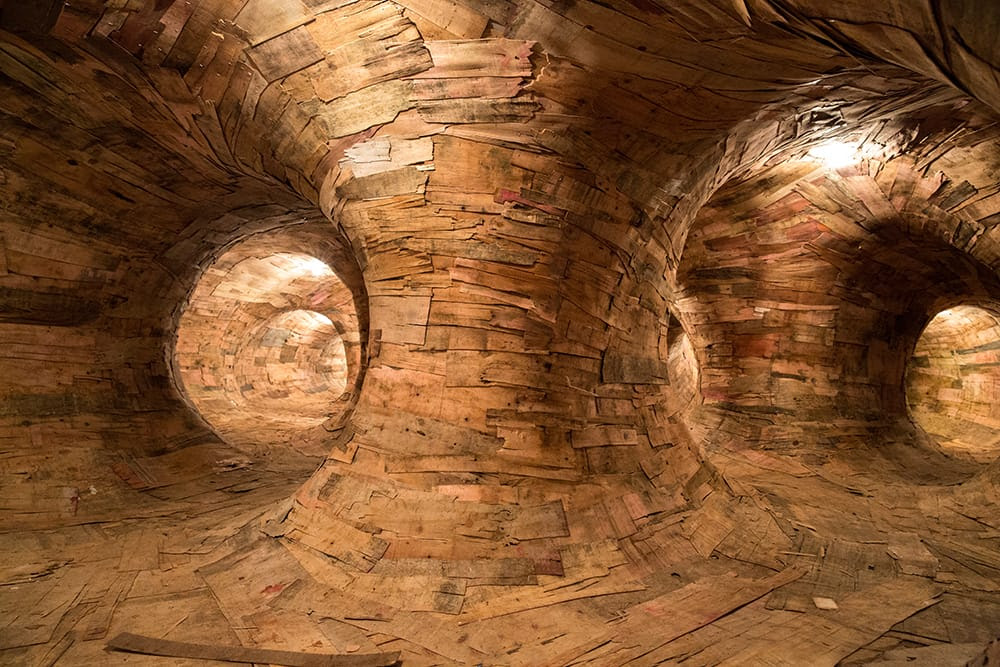 Artist Henrique Oliveira Constructs a Cavernous Network of Repurposed Wood Tunnels at MAC USP Artist Henrique Oliveira Constructs a Cavernous Network of Repurposed Wood Tunnels at MAC USP wood installation architecture
