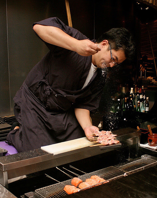 Chef Iwagami seasoning chicken wings with salt