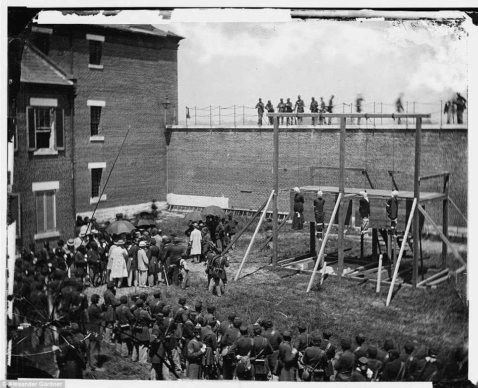 Bearing witness: Around 1,000 people gathered in the scorching Washington heat to watch the four conspirators hanged to death; reporters and military personnel can be seen in the background