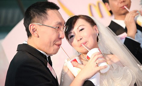 I'm shaking: The happy meal couple share a slurp at their wedding buffet