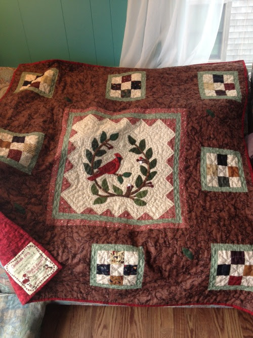 quilt Linda Sue Appliqué Block of the Month #2, Cardinal, in Mary Beth Hartnett’s Birds & Boughs series is ready to go to his home, a little late for Christmas.