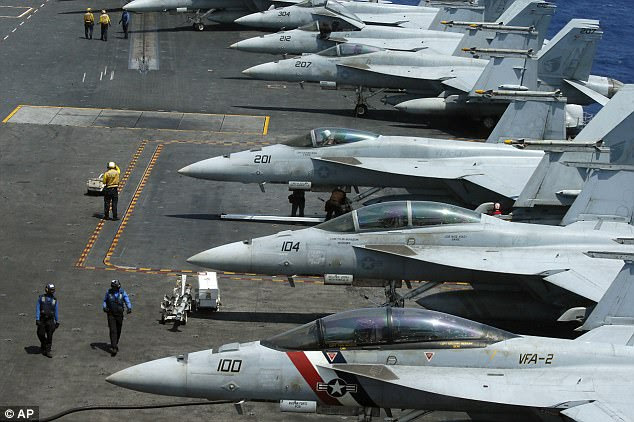 A row of F18 fighter jets on the deck of the USS Carl Vinson are pictured