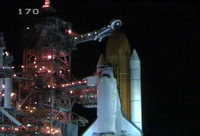 The tower's Rotating Service Structure rolls away...revealing Discovery as it stands poised for launch as of 12:14 AM (Eastern Daylight Time) on July 4th.