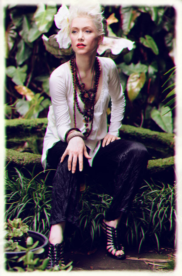 White top, black slacks, seated at a fish pond, Fashion Catalogue