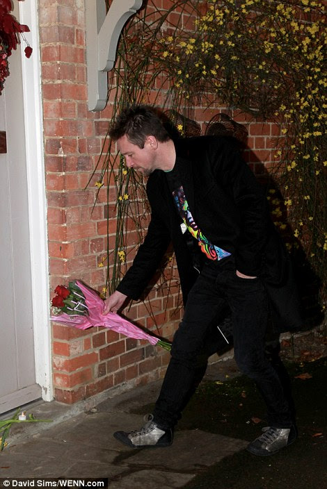 Fans have put flowers outside the cottage home where the singer was found dead by a friend yesterday