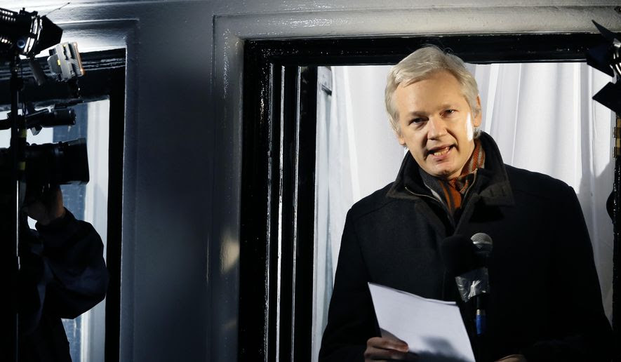 Julian Assange, founder of WikiLeaks, speaks to the media and members of the public from a balcony at the Ecuadorian Embassy in London in this Dec. 20, 2012, file photo. (AP Photo/Kirsty Wigglesworth, File)