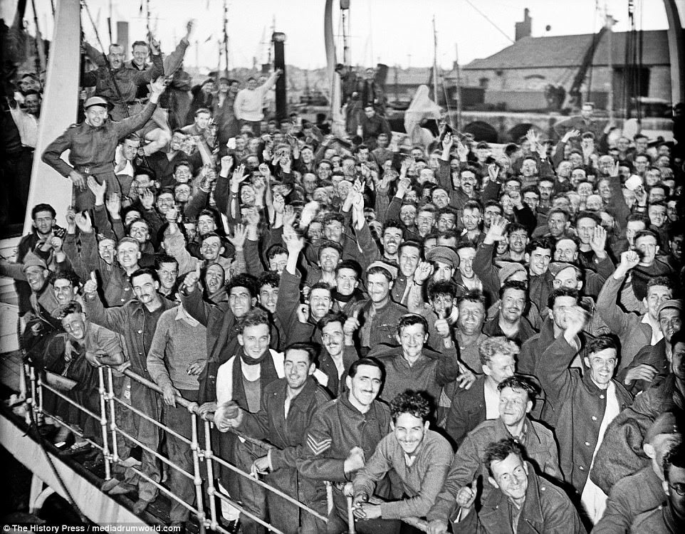 Despite it being one of the British army's greatest defeats, the soldiers are seen smiling and laughing as jubilant crowds handed out drinks upon their return from France - because it could have been a lot worse 