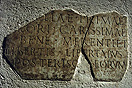 
[image ALT: A fragmentary Roman inscription set in a wall.]
   