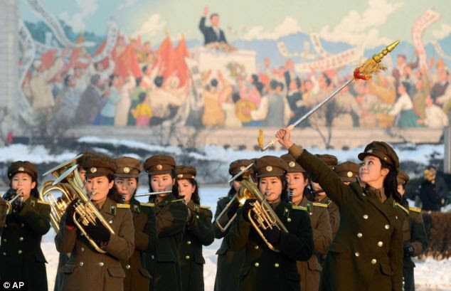 Celebrate success: Female members of a North Korean military band perform at the launch celebration and TV showed images of happy people dancing in the streets and others bursting into applause