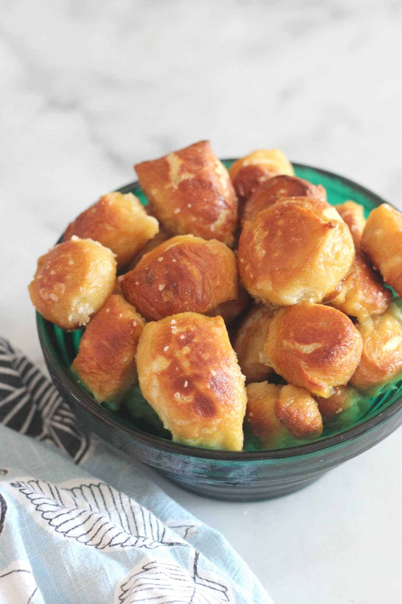 Don't be intimidated by these soft and chewy pretzel bites. They are easy to make at home and taste amazing! These bites are perfect as a party food or an after school snack!