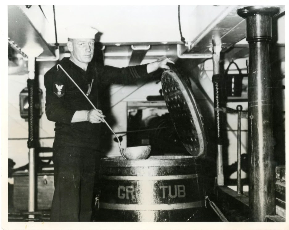 A sailor displays the old “Grog Tub” on USS Constitution in the 1930s