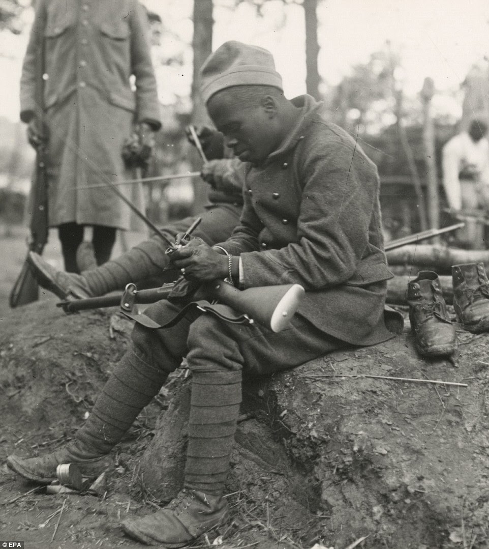 A Senegalese soldier cleans his rifle in France. At the outbreak of war in 1914, many of the soldiers moved from active duty in Northern Africa to be stationed in Europe
