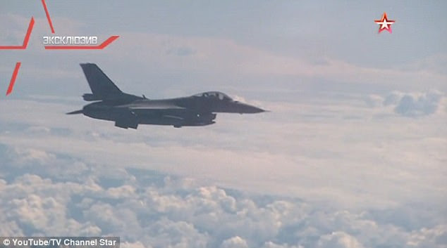Pictured: The F-16 coming very close to the plane containing defence minister Sergei Shoigu