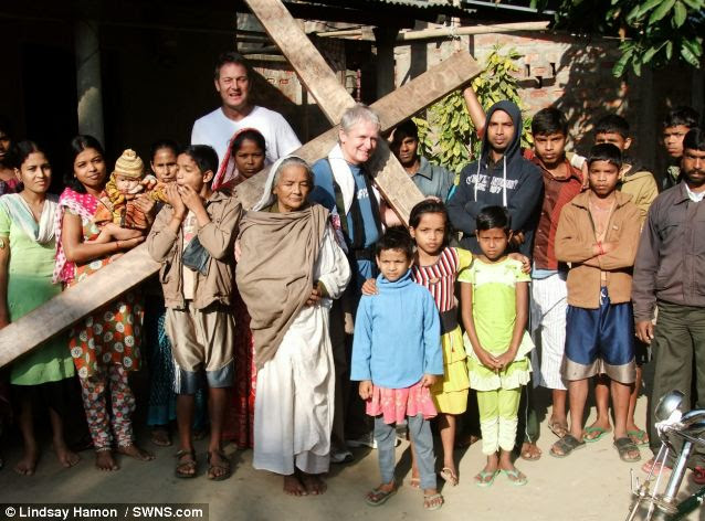Journey: Mr Hamon poses with his cross in Assam. He first took up the 12ft 6in tall cross in 1987 and has spent only a handful of days without it