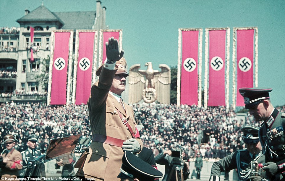Salute of a tyrant: Hitler and his henchmen of the Legion Condor and aircraft division, the Luftwaffe, at a rally in Germany held in their honour in front of thousands of citizens under swastika banners