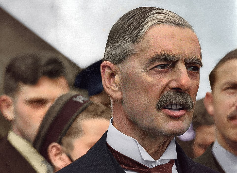 Appeasement: British Premier Sir Neville Chamberlain is pictured here on his return from talks with Hitler in Germany, at Heston airfield, London, on September 24, 1938. Chamberlain brought with him a terms of the plan later to be called the Munich Agreement, which allowed Germany to annex Czechoslovakia's Sudetenland