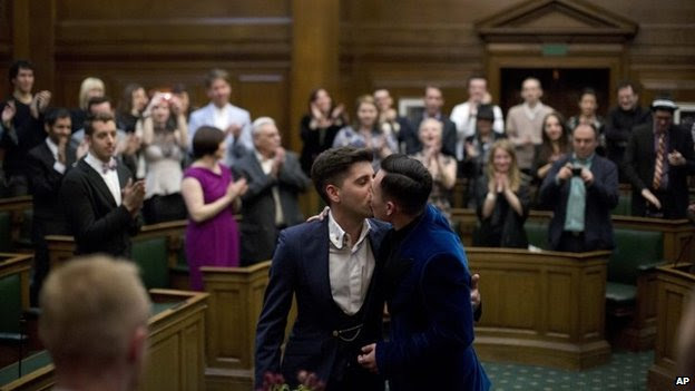 Newly married men kissing