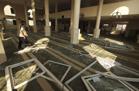 A Palestinian man surveys the damage in Bin Zayed mosque after an Israeli air strike in Gaza