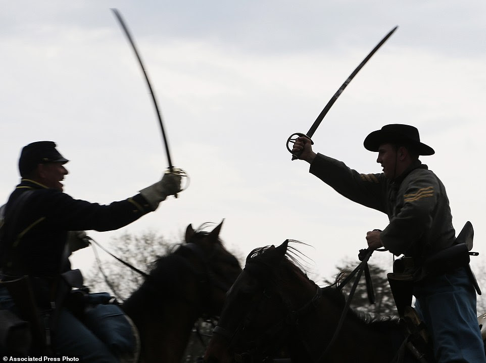 Confederate and Union forces clash during a re-enactment of the Battle of Appomattox Station on Wednesday as part of the 150th anniversary of the surrender of the Army of Northern Virginia to Union forces at Appomattox Court House, in Appomattox, Virginia
