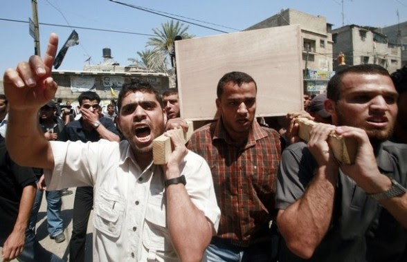 Palestinians carry the body of Monther Qreqa during his funeral in Gaza City