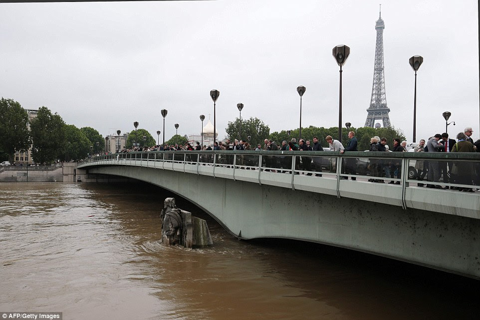 Tourists unable to get into museums and attractions instead spent time taking pictures of the rising flood waters