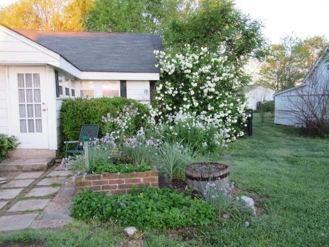 photo corner back porch with herb bed in front_zpsnepeesyv.jpg