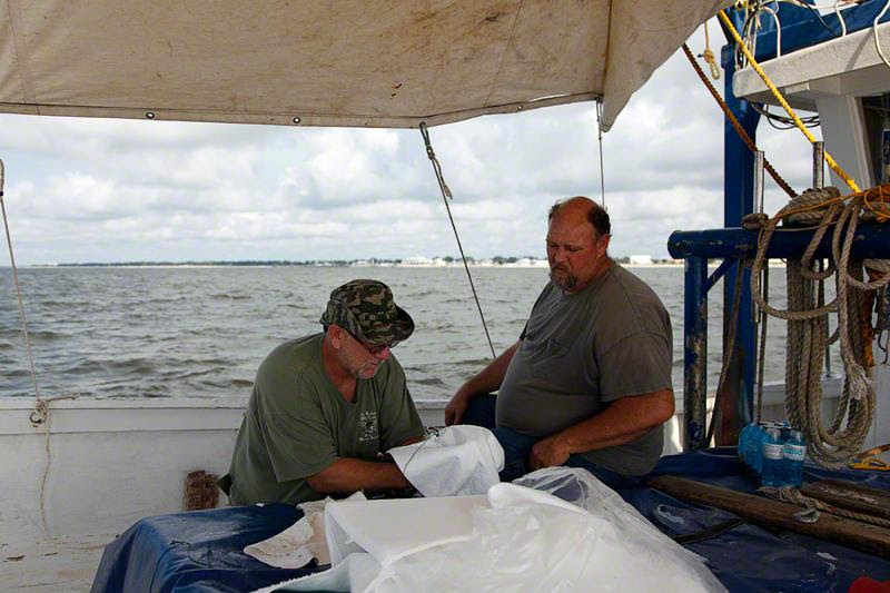 Miller and Mark Stewart attaching the sorbent pad to the weighted hook.