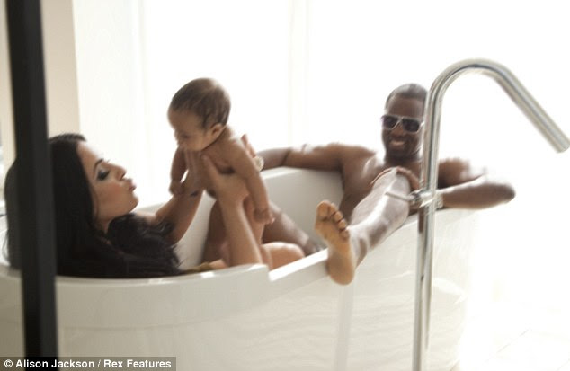 Pucker up: Kim pulls one of her famous pouts to entertain her baby girl