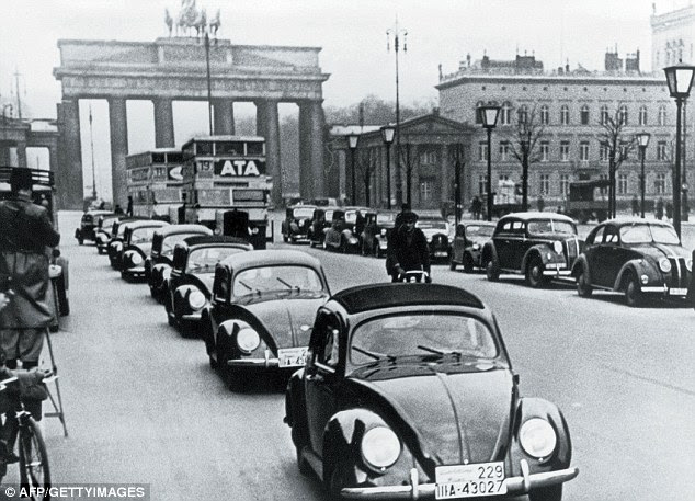 Brand new: The very first Beetles of the preproduction series VW 38 roll onto the streets in front of Berlin's Brandenburg Gate in 1938