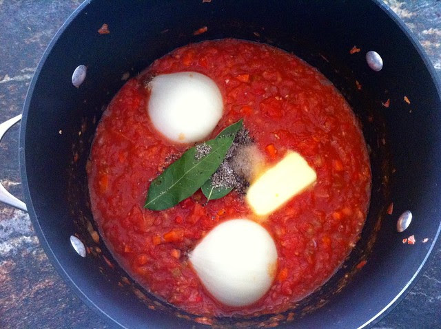 Onion Halves and Butter Added to Marinara