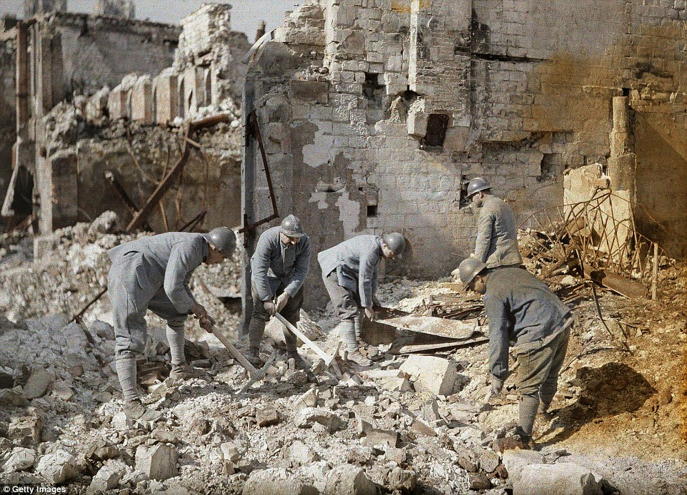 Five French soldiers are clearing the rubble in the ruins of Reims, which was almost 60 per cent destroyed by German artillery and air raids