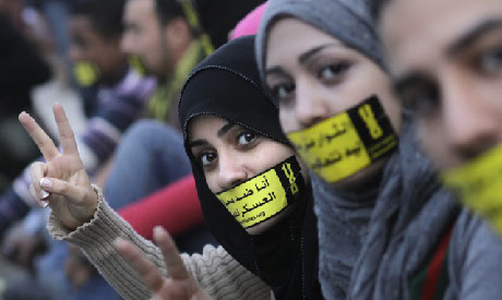 File photo of Egyptian activists with stickers that read: "No to military trials for civilians" at a File photo of Egyptian activists with stickers that read: "No to military trials for civilians" at a