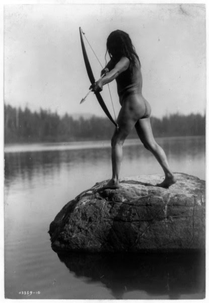 Description of  Title: The Bowman--Nootka.  <br />Date Created/Published: c1910.  <br />Summary: Rear view of nude Indian standing on rock in water and aiming arrow.  <br />Photograph by Edward S. Curtis, Curtis (Edward S.) Collection, Library of Congress Prints and Photographs Division Washington, D.C.
