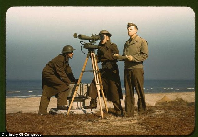 Setting sight: Men operate an azimuth instrument, to measure the angle of splash in sea-target practice at Fort Story in Virginia (Alfred Palmer, March 1942)